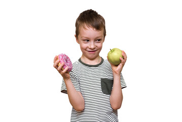 the boy holds a donut and an apple in his hands on a white background. child food choice fruit or sweet donut.