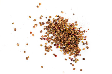 Whole dried sumac berries scattered pile isolated over white