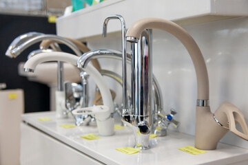 Kitchen faucets on shelf closeup, plumbing shop