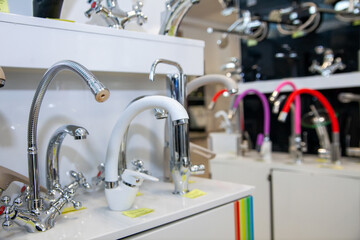 Kitchen faucets on shelf closeup, plumbing shop
