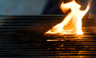 Blurred photo of fire on the barbecue. Close-up of fire view. Blurred motion and noise included