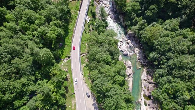 Beautiful aerial view of old double arc stone bridge at village Lavertezzo, Canton Ticino, with Verzasca River on a sunny summer day. Movie taken July 26th, 2022, Lavertezzo, Switzerland.