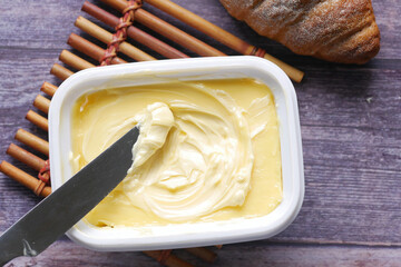 close up of fresh butter in a container 