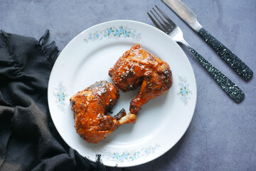  slice of a BBQ chicken from a plate top view 