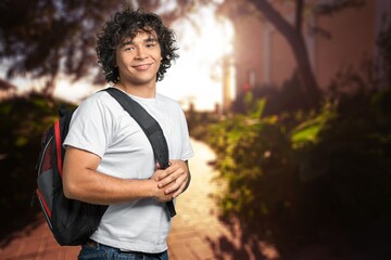 Smiling student walking outdoor in a college courtyard outdoor