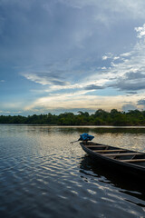 Fototapeta premium Beautiful sunset on the Amazona river with the wooden boat