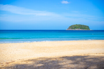 Empty clean beach with white sand and blue sea on a sunny day. Tropical island in the sea.