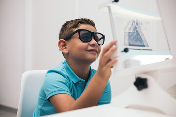 A child undergoes a polarized convergence/divergence test at an optician. vision therapy