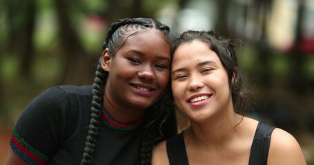 Diverse girlfriends smiling at camera together. Ethnically diversity women