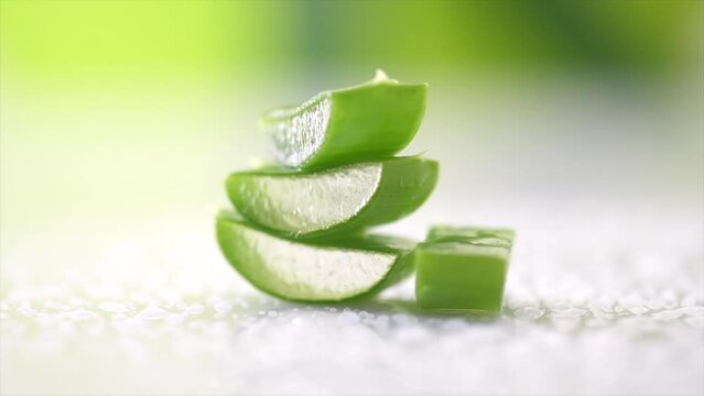 Aloe Vera closeup. Slices of Aloevera plant leaf, gel, natural organic renewal cosmetics, alternative medicine. Moisturizing, Skin care concept. Rotation, white background. Slow motion