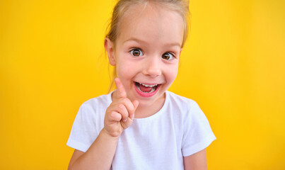 Clever little girl with bright idea pointing upwards her finger gain attention