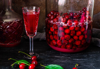 Homemade liqueur from cherries in a jar of a natural fermentation process. Ukrainian tincture.