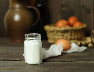 Milk in a jar and chicken eggs in the kitchen