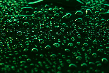 Beautiful macro photo of water drop reflection, lying on surface, front view. Close up of liquid with side lighting from displays.
