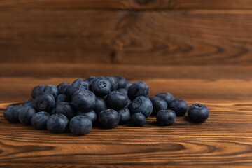 Blueberries on a brown texture background. Ripe and fresh blueberries. Vitamins. Healthy food. Juicy berry. Copy space. Place for text