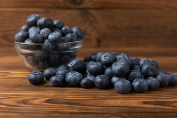Blueberries on a brown texture background. Ripe and fresh blueberries. Vitamins. Healthy food. Juicy berry. Copy space. Place for text