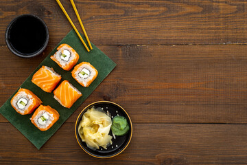 Japanese cuisine. Salmon sushi rolls on eco green papper plate