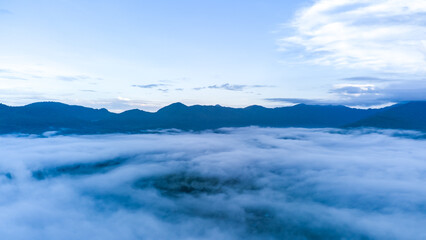Obraz na płótnie Canvas blue sky background with sea of fog,sky over hill in summer season morning sunrise
