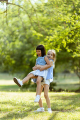 Cute asian and caucasian girl having fun in the park