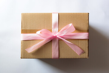 Cardboard box with a pink ribbon. Gift