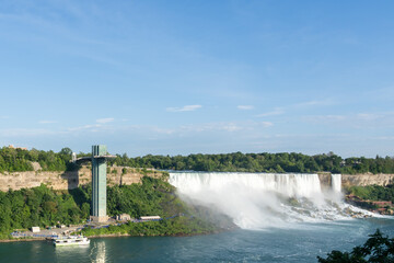 Niagara Falls, ON, Canada - July 23, 2022: Niagara Falls Observation Tower and falls on the U.S....