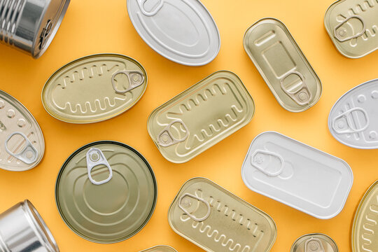 Row of cans on a yellow background