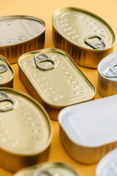 Row of cans on a yellow background
