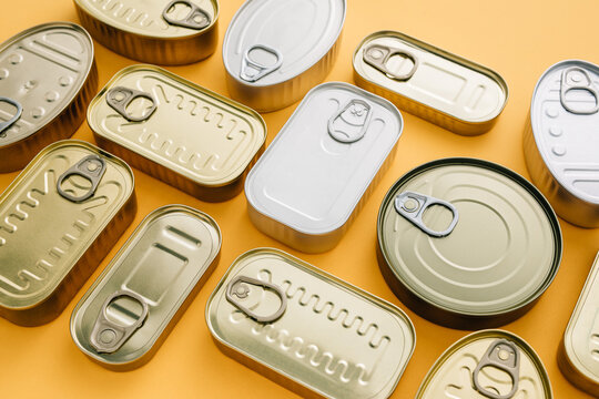 Row of cans on a yellow background