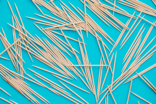 A bunch of toothpicks on a blue background