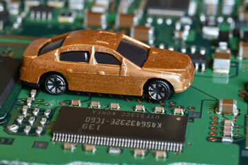 Toy cars on electronic board and microchip. Conceptual image for semiconductor shortage disrupting...
