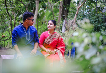 South asian newly married couple with traditional dress, husband and wife in a outdoor natural...