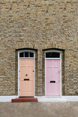 Two identical pink doors in London, England.