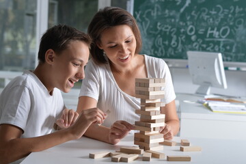 Woman and  boy playing with wooden  blocks together