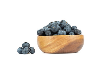 Blueberries in a wooden bowl and on a white background.