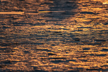 Stone block pavement in the rays of the setting sun. Texture