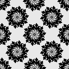 Seamless pattern with mandala ornament. Black on a white background. Modern stylish abstract texture. Repeating geometric elements for web or textile. Vector illustration