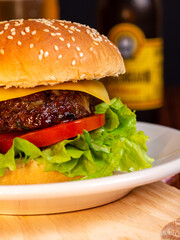 Burger with salad and cheese, with beer on wooden table