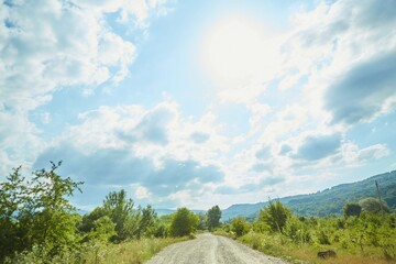 A rural gravel road stretching into the distance. The concept of travel and adventure.