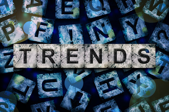 Trends, word on an alphabet on stone blocks, on dark blue background.Business.