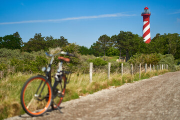 Lighthouse in Holland. Bike on the way. Cycling in Netherlands, Zeeland, West Schouwen.