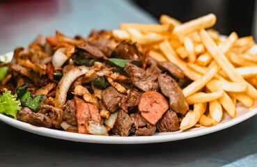 Mixed portion with calabrian. chicken, onion, meat, chili and chips coming out to the table