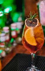A special amazing drink served with oranges. dried fruit and rosemary at Villa Europa Pub, a Brazilian bar with European details.