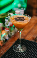 Special drink served with dried fruits and rosemary at the counter of a Pub bar in Brazil