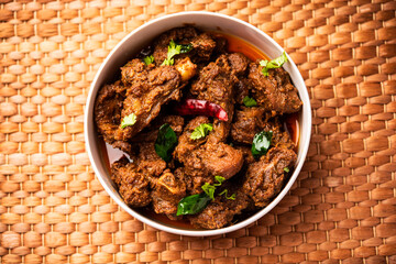 Sukha mutton or chicken, dry spicy Murgh or goat meat served in a plate or bowl - obrazy, fototapety, plakaty