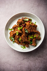 Sukha mutton or chicken, dry spicy Murgh or goat meat served in a plate or bowl