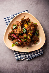 Sukha mutton or chicken, dry spicy Murgh or goat meat served in a plate or bowl
