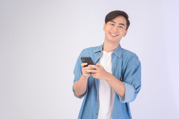Young asian man using smartphone over white background, technology concept. ..