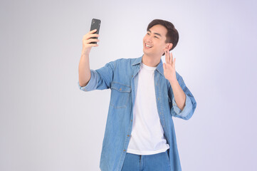 Young asian man using smartphone over white background, technology concept. ..