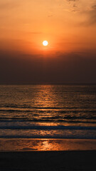 sunset on the beach with mountains