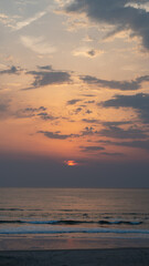 sunset on the beach with mountains